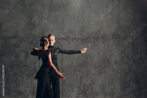 Young couple in black dancing ballroom dance Paso Doble