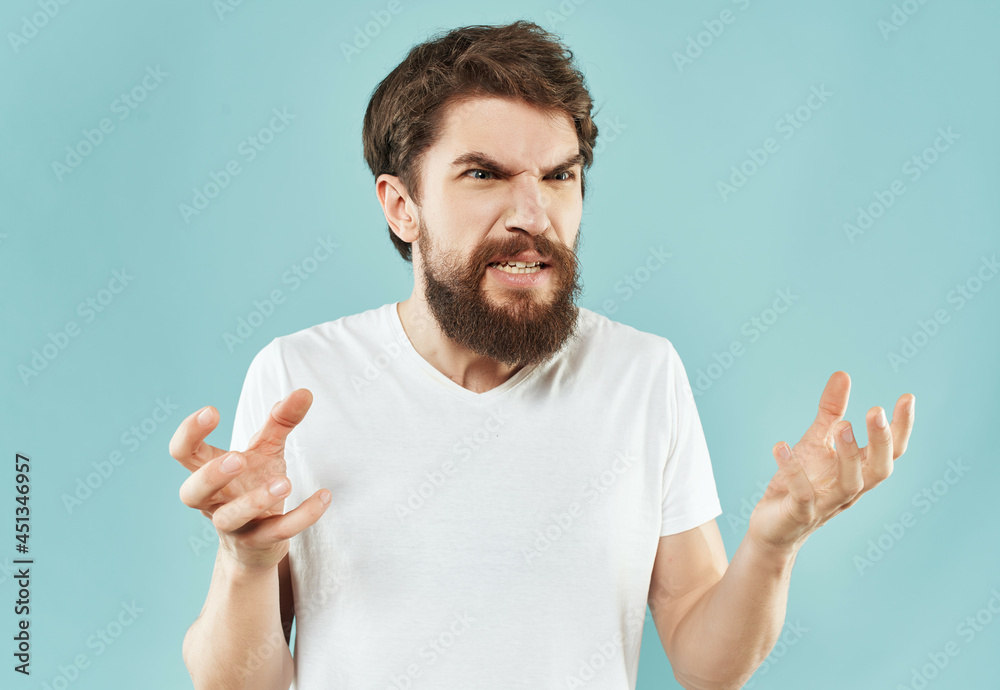 Man in a white t-shirt irritated facial expression close-up Man in a white t-shirt irritated facial expression close-up