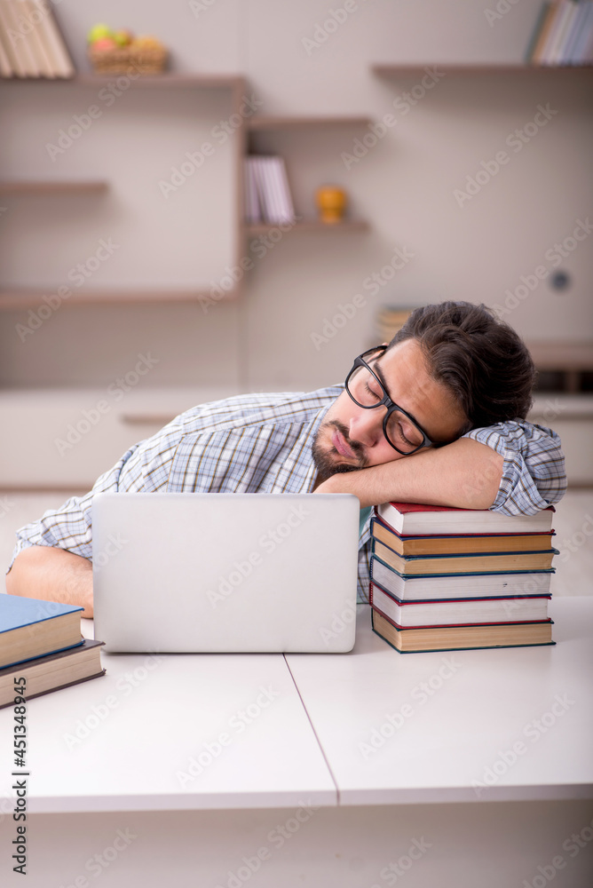 Young male student preparing for exams at home Young male student preparing for exams at home