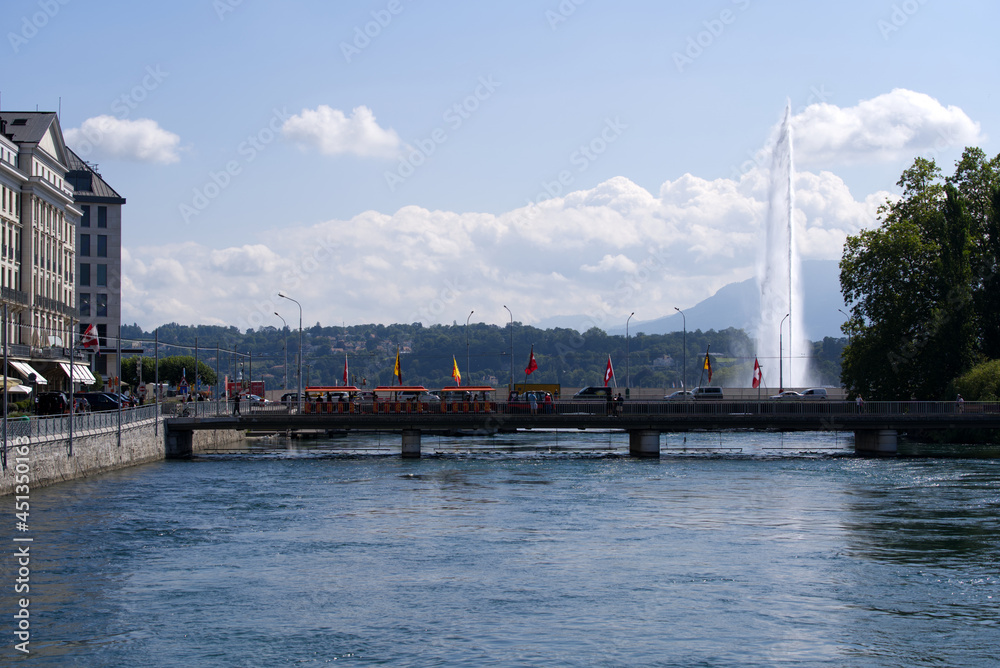 Fototapeta premium River Rhone at City of Geneva with bridges in the background on a sunny summer morning. Photo taken July 29th, 2021, Geneva, Switzerland.