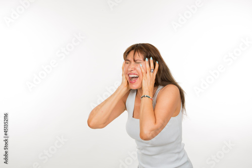 Caucasian senior woman with hands on face with expression of joy with closed eyes on white background photo