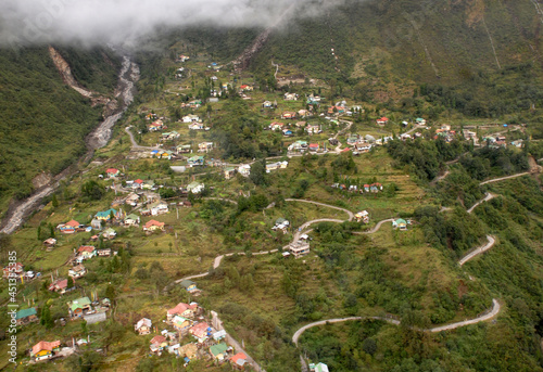 An areal view of Lachung village as seen from the chopper top during monsoon, situated at 8000 ft altitude in North Sikkim. This is the most popular tourist destination of Sikkim. photo