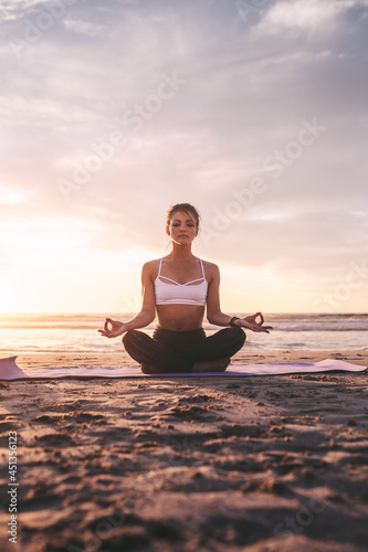 Woman meditating in lotus pose.