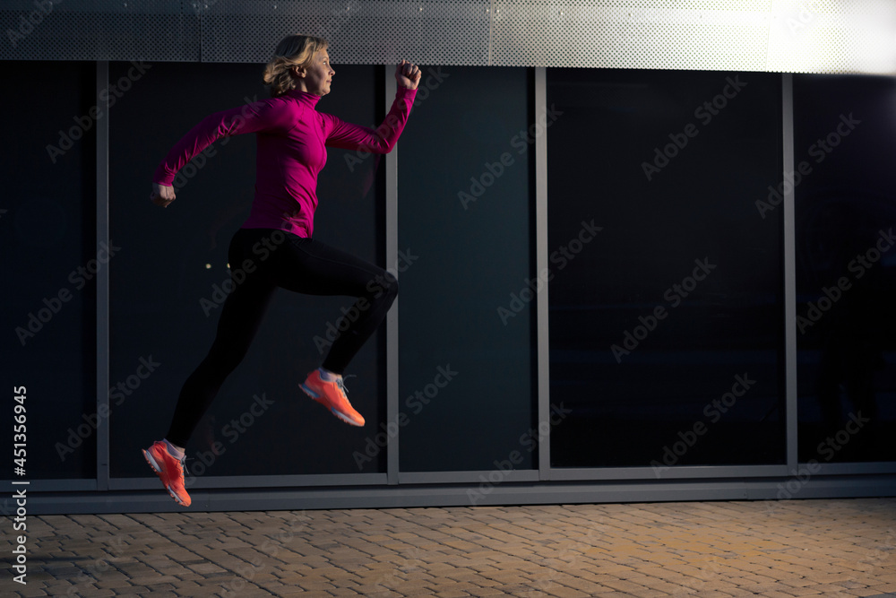 Professional Mature Senior Runner Having Outdoor Jogging Training Against Reflective Glass Surface Background.