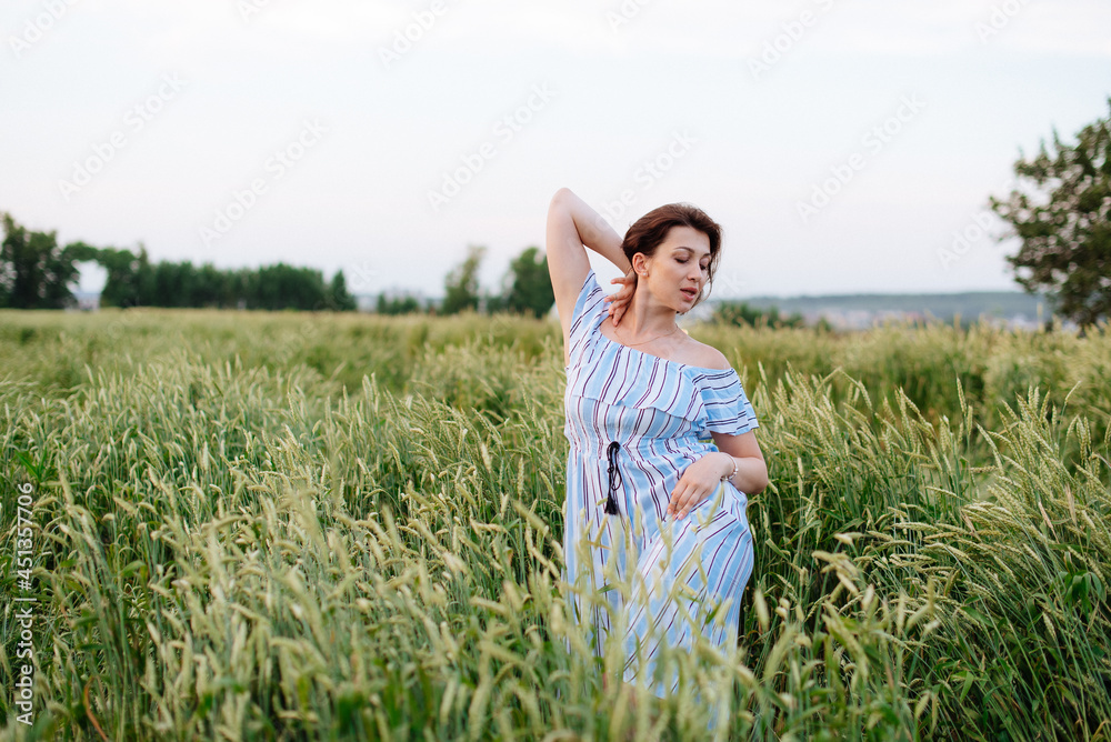 Beautiful young woman in summer in a wheat field Beautiful young woman in summer in a wheat field