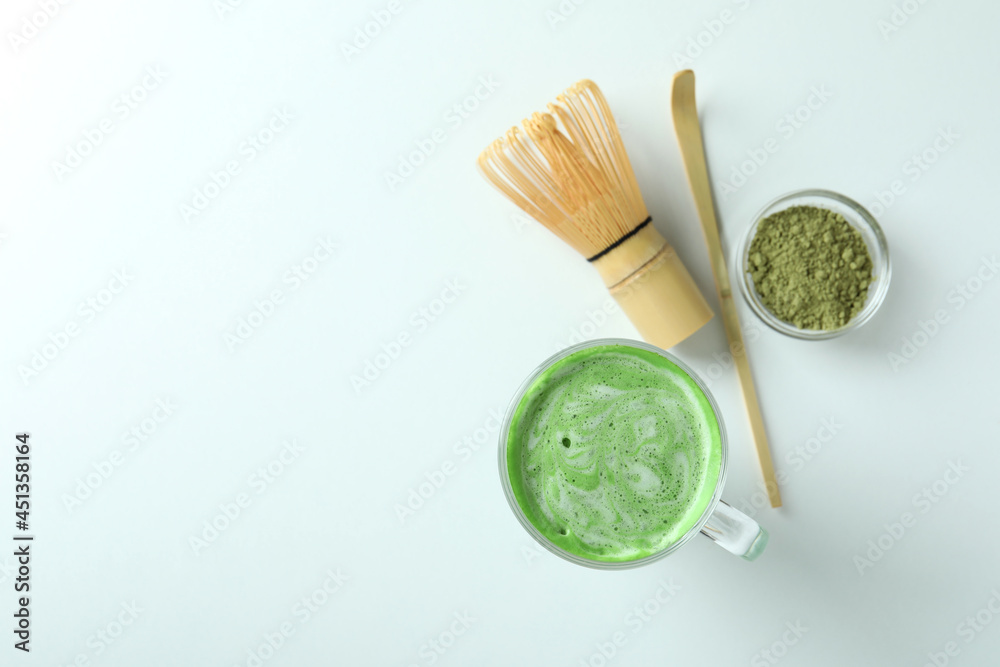 Matcha latte and accessories for making on white background Matcha latte and accessories for making on white background