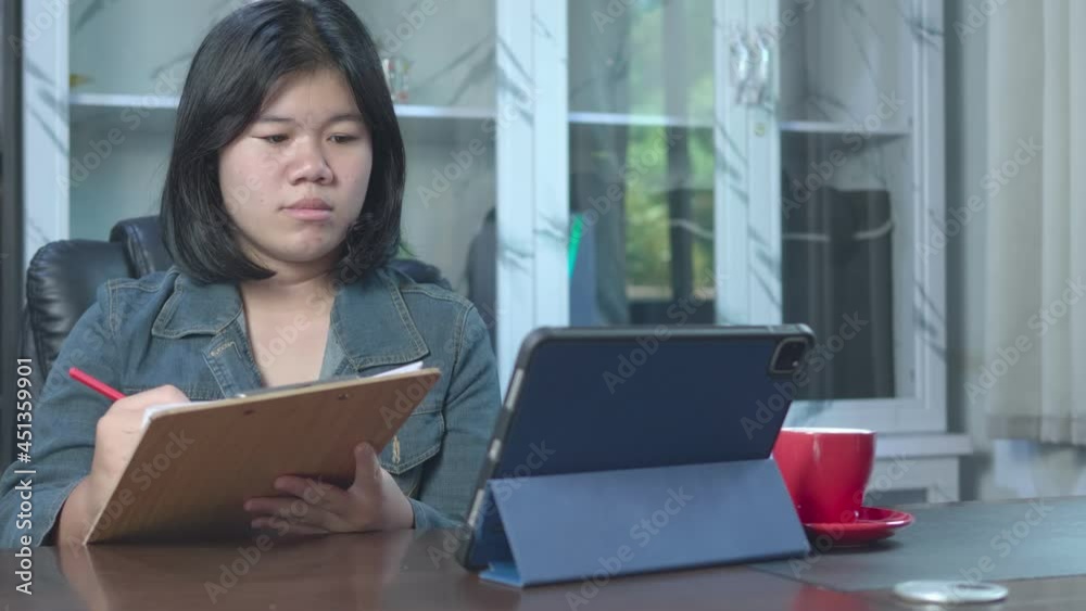 4k slow motion of Asian freelancer using tablet working video conference with a customer in home office. Marketing and financial. Deal with customers by online apps. Online selling and receiving order 4k slow motion of Asian freelancer using tablet working video conference with a customer in home office. Marketing and financial. Deal with customers by online apps. Online selling and receiving order