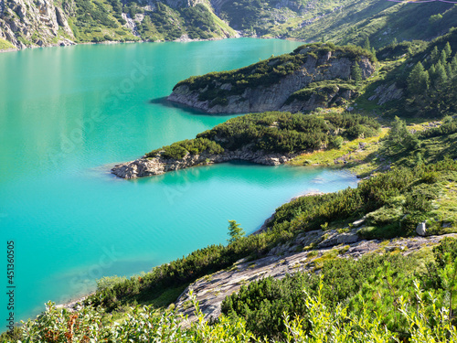 Landscape of the Lake Barbellino an alpine artificial lake. Turquoise water. Italian Alps. Italy. Orobie. Summer time. Relaxing contest. Close up to the shores of the lake