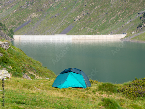 Tourist tent among a mountain meadow and a lake. Freedom and in solitude holidays. Natural contest. Relaxing time. Summer. General contest © Matteo Ceruti