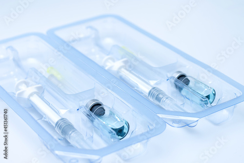 Wallpaper Mural Covid-19, flu, coronavirus liquid vaccine vial bottle and syringe set in plastic package container preparing for injection on white background. Vaccination for fight Covid-19 virus concept. Torontodigital.ca