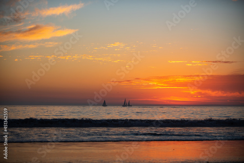 Ocean sunset on sky background with colorful clouds. Calm sea with sunrise sky. © Volodymyr