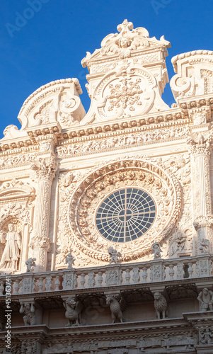 exquisite work in the Baroque style, excellent exteriors of the facades of the Basilica of Santa Croce, emphasis on the rich framing of the stained glass and colonnade