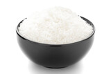 Close-up of white dry  desiccated organic coconut in a black ceramic bowl over white background.