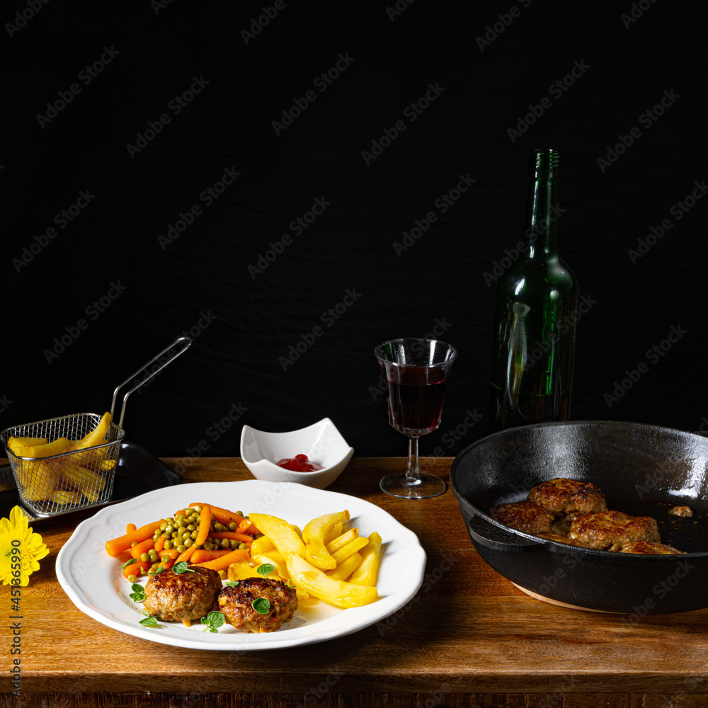 Homemade meatballs with french fries and vegetables Homemade meatballs with french fries and vegetables