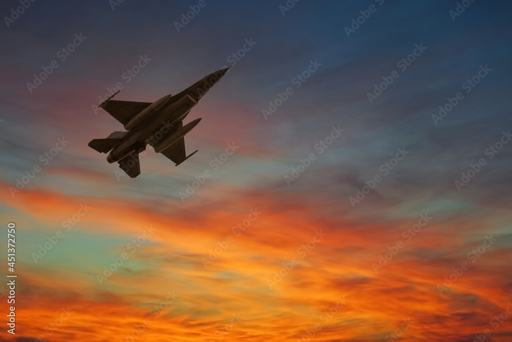 Silhouette airplane flying with beautiful colorful twilight sky background.