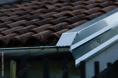 House: building with pitched roof with brick tiles, visible in the way the eaves, and front of the cornice. roofing project with energy certifications. photo