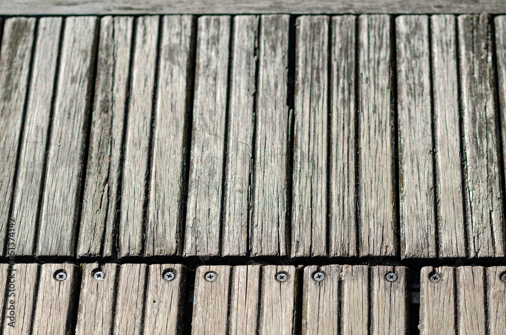 Fototapeta premium outdoor wooden floor, natural colored wooden strip, for walking, weatherproof, for coverings and walkways with joints and screws.