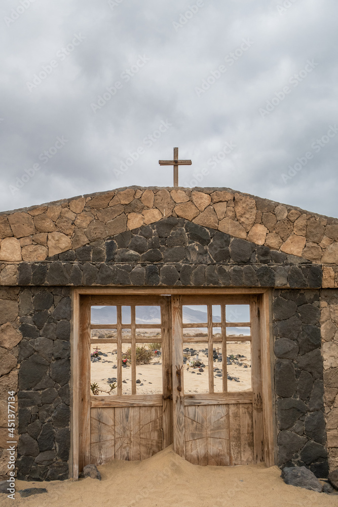Facade of Cofete cemetery with sand on the island of Fuerteventura