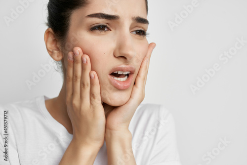 woman holding face toothache discontent discomfort