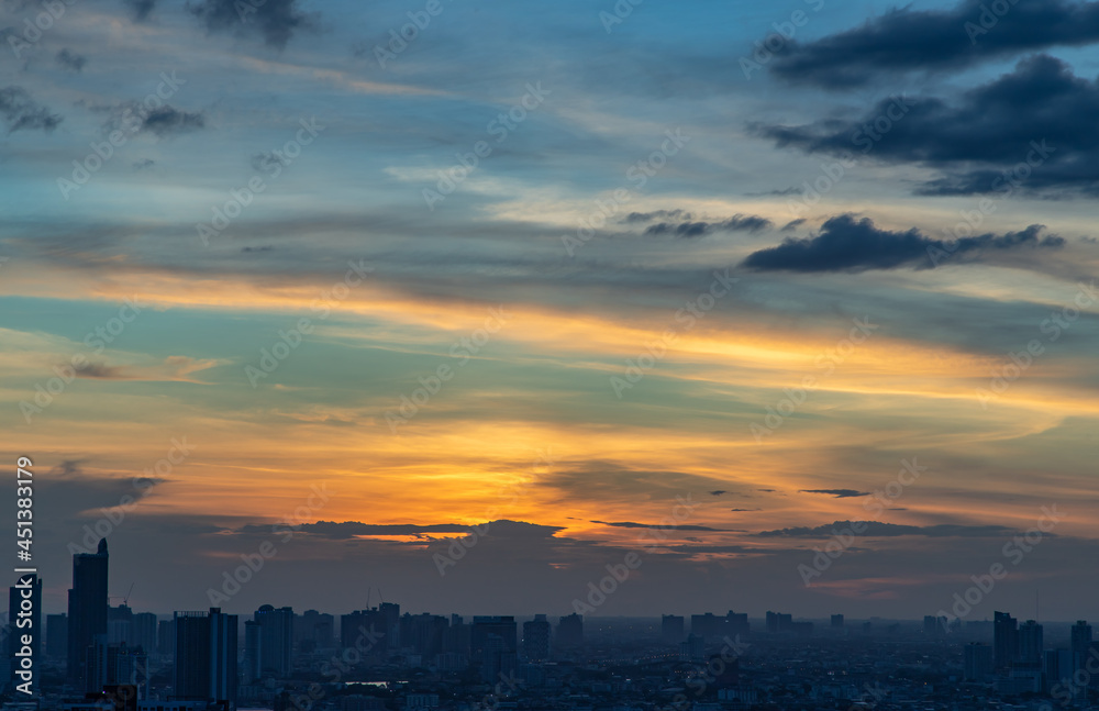 The sun shines through the clouds in the sunset sky with dramatic light. The shape of the clouds evokes imagination and creativity. They can be used as wallpapers that look amazing. Copy space, Select The sun shines through the clouds in the sunset sky with dramatic light. The shape of the clouds evokes imagination and creativity. They can be used as wallpapers that look amazing. Copy space, Select