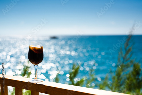 Summer drink cold cocktail with amazing sea view in background. Vacation concept.