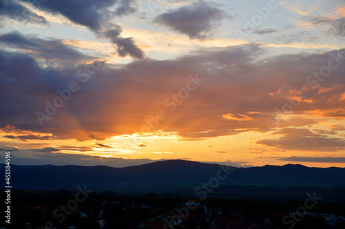 colorful cloudy sunset sky over the hill © Jana