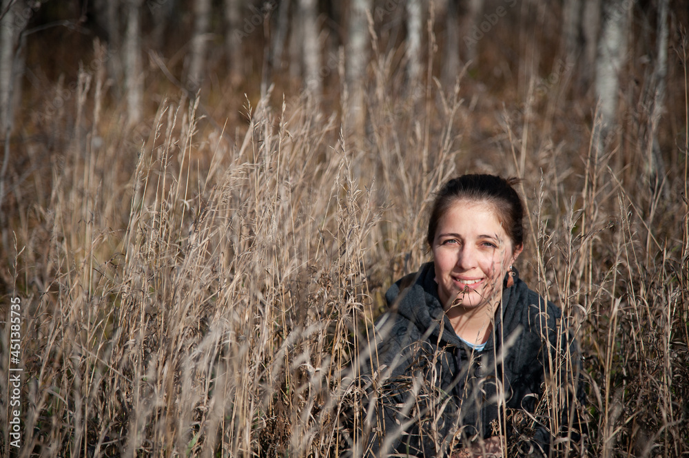 girl sitting in autumn dry flowers girl sitting in autumn dry flowers