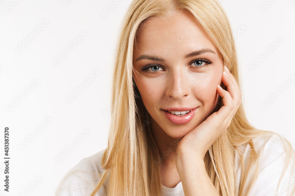 Young blonde woman in t-shirt smiling and looking at camera Young blonde woman in t-shirt smiling and looking at camera