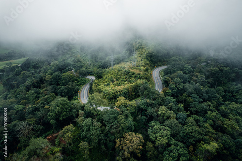 Mountain road in rainy and foggy day