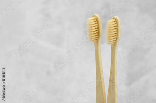 Eco-friendly toothbrushes. Two bamboo toothbrushes on a concrete background with place for text. Dental eco-friendly concept. Oral cavity care.