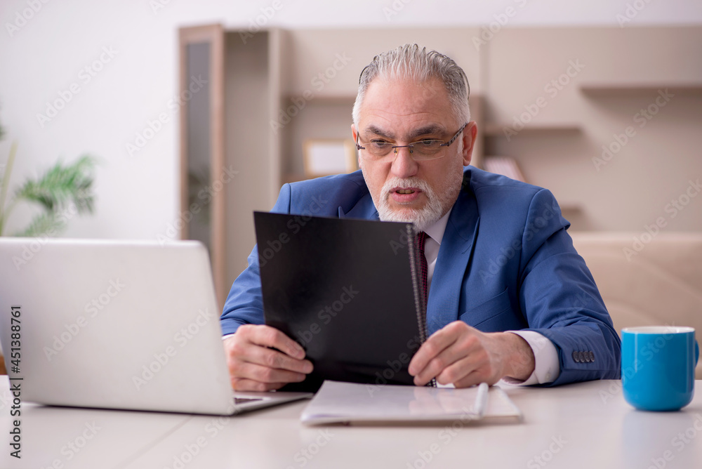 Old male employee working from home during pandemic Old male employee working from home during pandemic