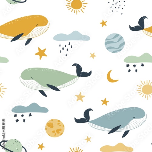 Cute whales among the clouds and planets. Seamless background in pastel colors.