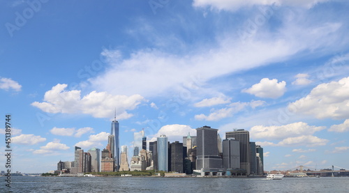 Lower Manhattan skyline from Governors Island, big blue sky and clouds above