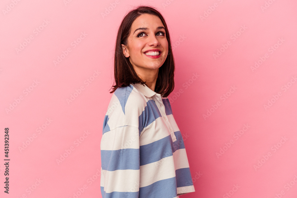 Young caucasian woman isolated on pink background relaxed and happy laughing, neck stretched showing teeth. Young caucasian woman isolated on pink background relaxed and happy laughing, neck stretched showing teeth.