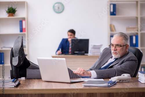 Two male employees working in the office