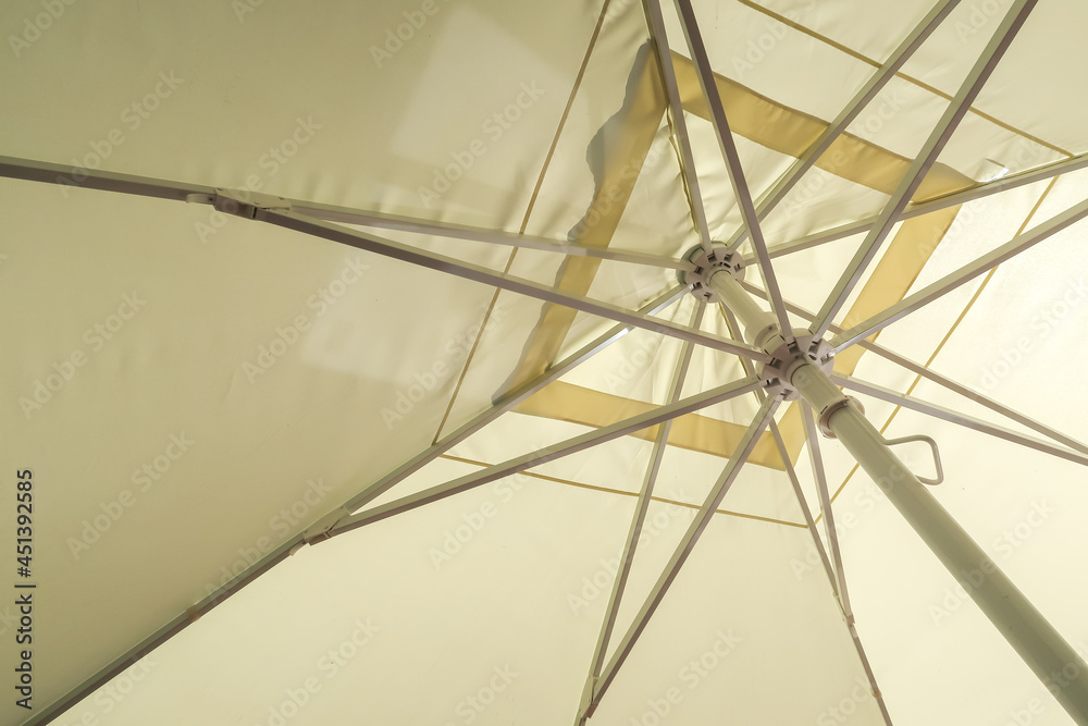 Fototapeta premium sand-colored parasol from the inside as a background