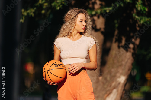 Portrait of young female basketball player. © vitleo