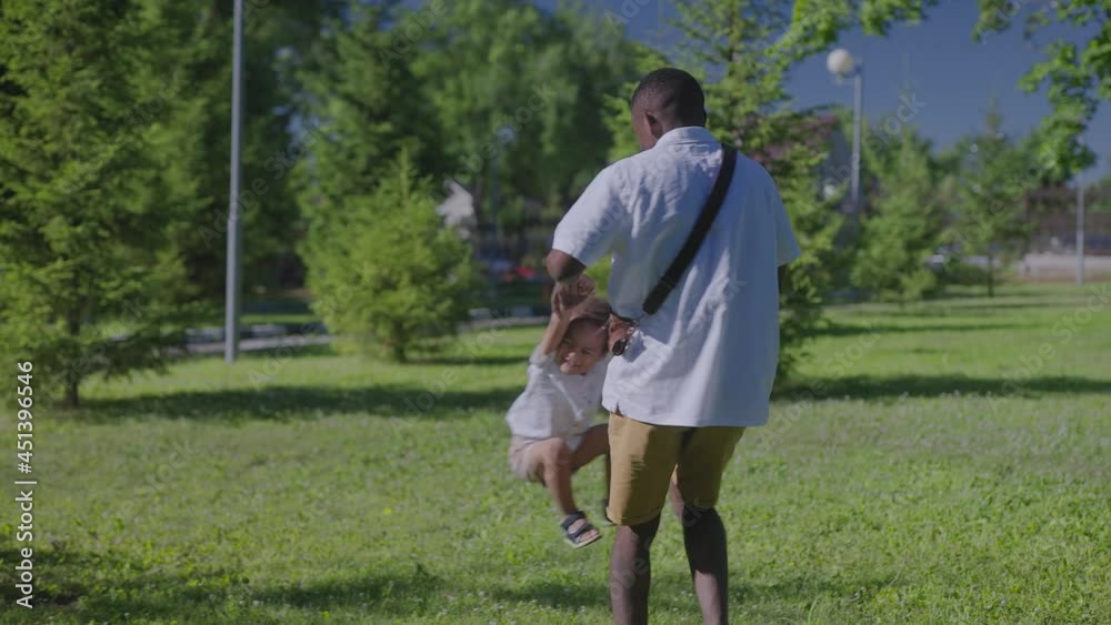 African American father with his son in the park. Father and son have fun. African American father with his son in the park. Father and son have fun.