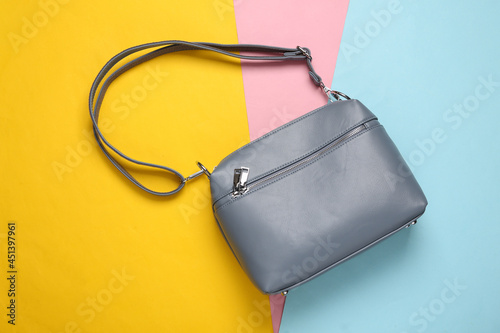 Fashionable leather bag on a colored pastel background. Top view