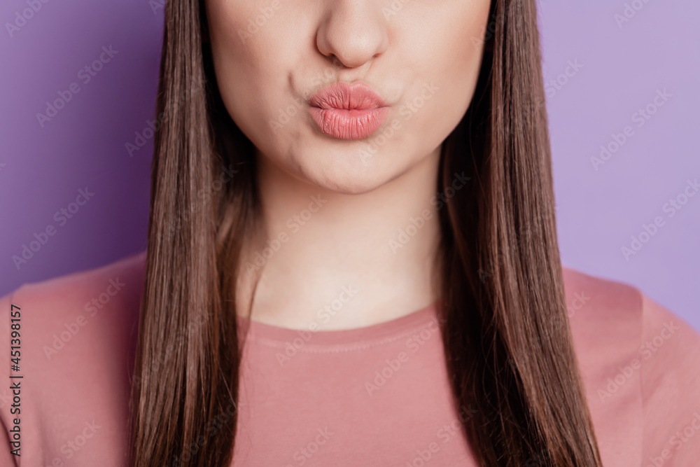 Close up cropped photo of charming pretty cute nice girl demonstrated pouted lips after injection isolated violet color background Close up cropped photo of charming pretty cute nice girl demonstrated pouted lips after injection isolated violet color background