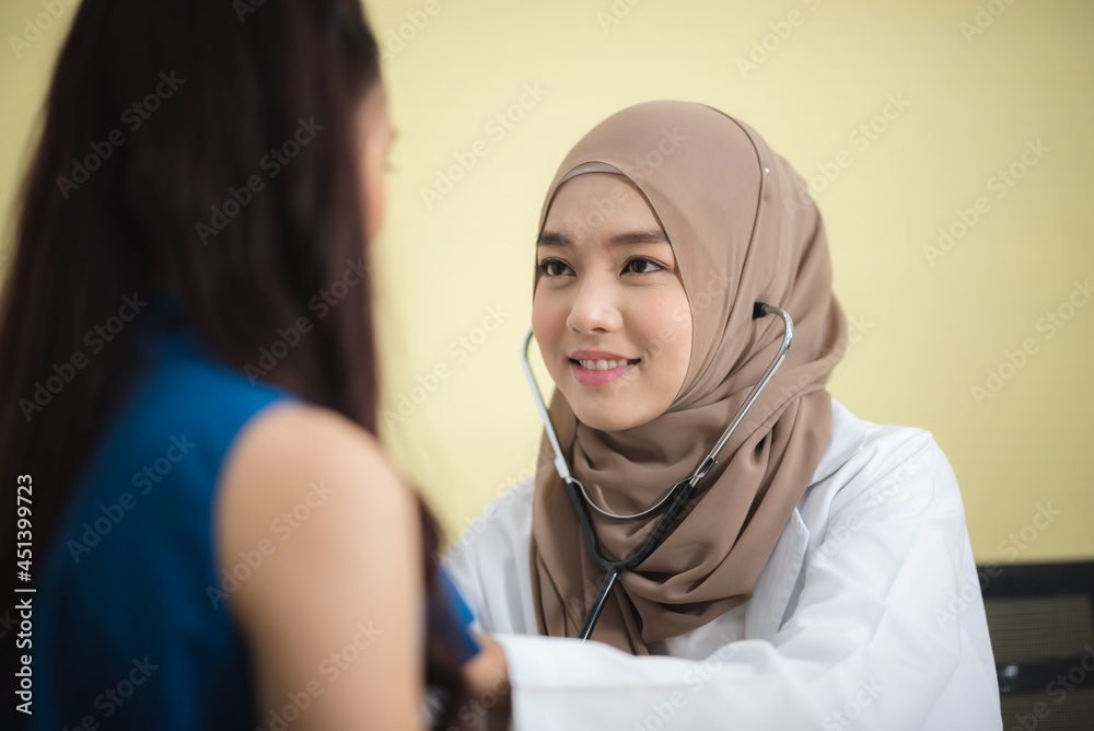 muslim women wearing brown hijab using stethoscope for medical check-up,  health care concept, smiling confident young lady, yellow background, asian  patient black long hair. Stock Photo | Adobe Stock