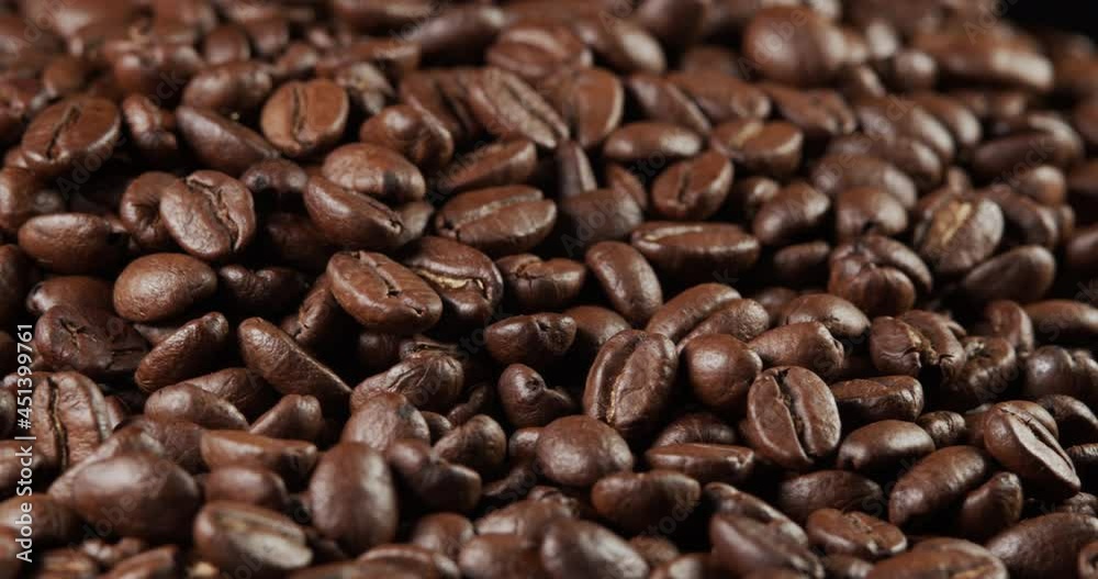 Roasted coffee bean. Fragrant coffee beans scrolls slowly around the camera. Slow Motion Close Up of Whole Roasted Coffee Beans. Roasted coffee bean. Fragrant coffee beans scrolls slowly around the camera. Slow Motion Close Up of Whole Roasted Coffee Beans.