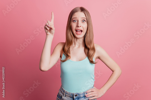 Portrait of genius smart excited lady raise finger have great idea on pink background