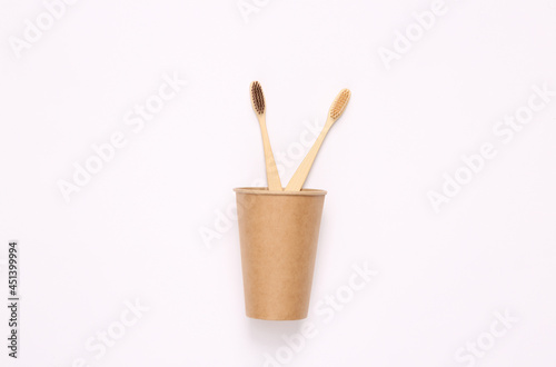 Plastic free toothbrushes in a cup. Zero waste, eco friendly concept. Flat lay.
