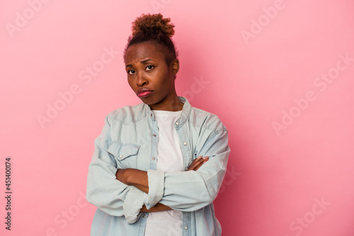 Young african american woman isolated on pink background who is bored, fatigued and need a relax day.