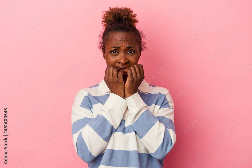 Young african american woman isolated on pink background biting fingernails, nervous and very anxious. Young african american woman isolated on pink background biting fingernails, nervous and very anxious.