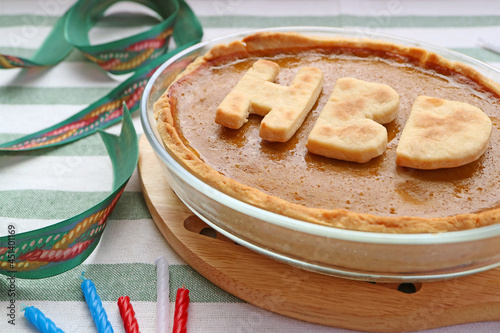 Delectable Fresh Baked Pumpkin Pie Topped with HBD Alphabets for Birthday Celebration