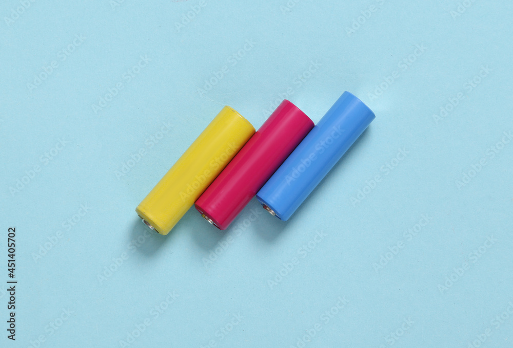 Colored aa batteries on a blue background Colored aa batteries on a blue background