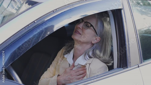 Adult woman driver stopping car feeling sudden sharp pain in chest, emergency