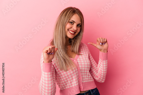 Young russian woman isolated on pink background feels proud and self confident, example to follow.